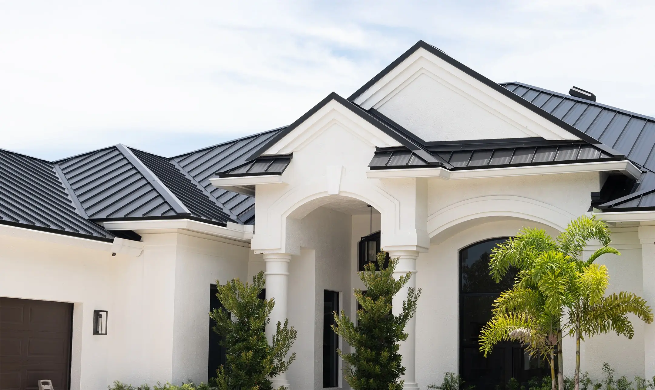 White Florida home with a black standing seam metal roof