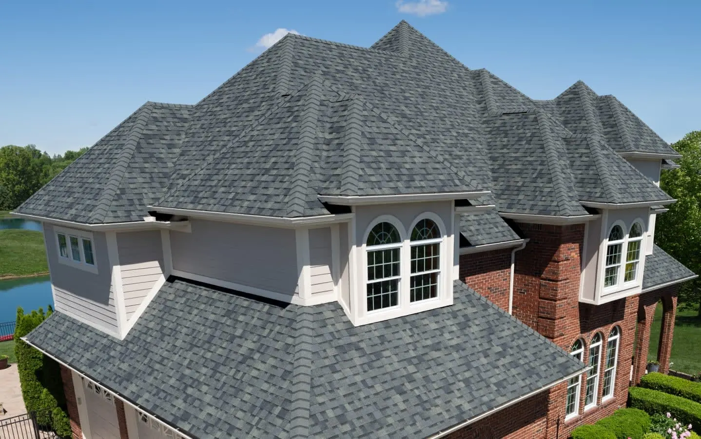 Brick home with a gray architectural shingles roof