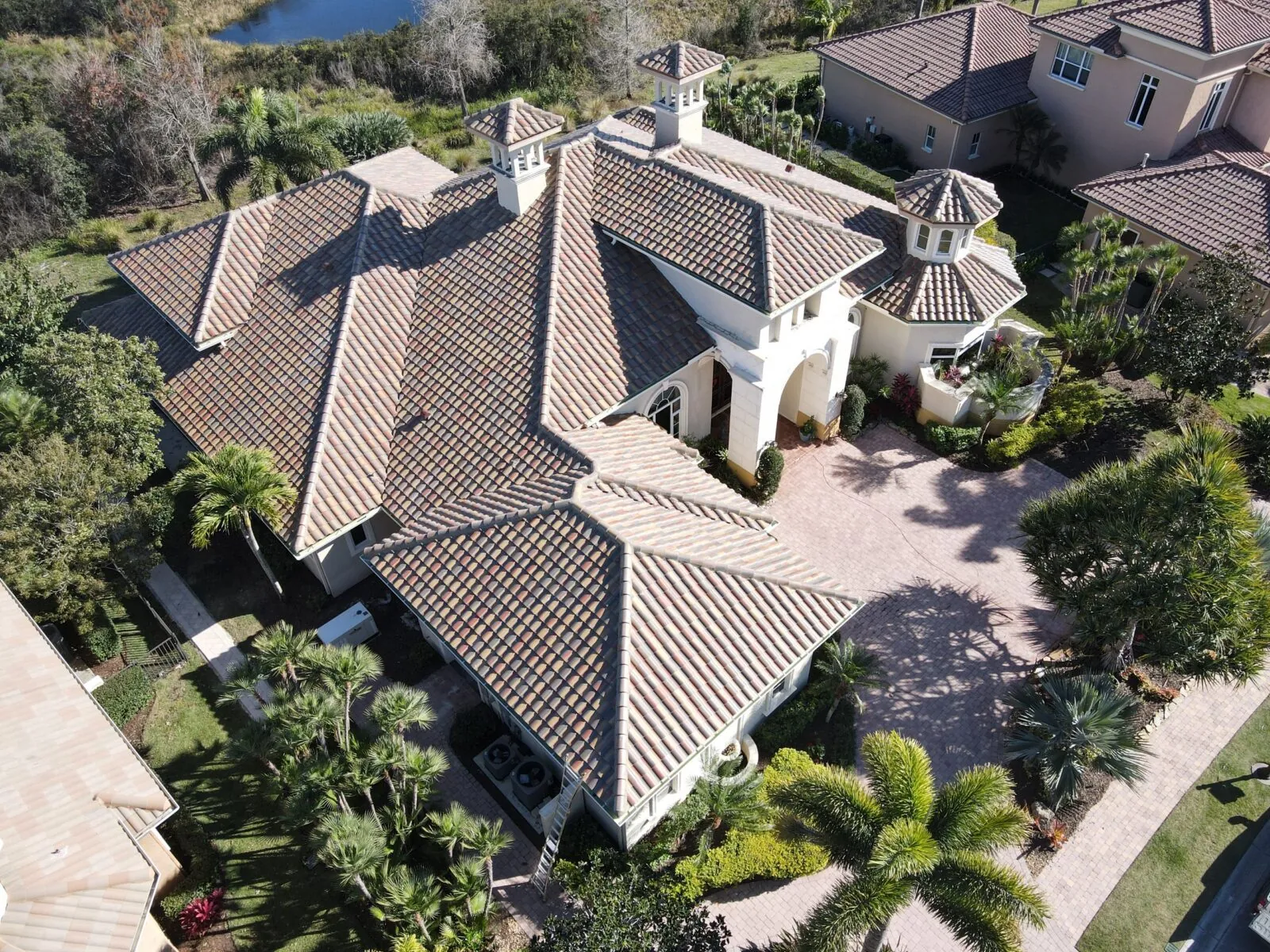 Aerial view of a large Florida home with a spanish tile roof