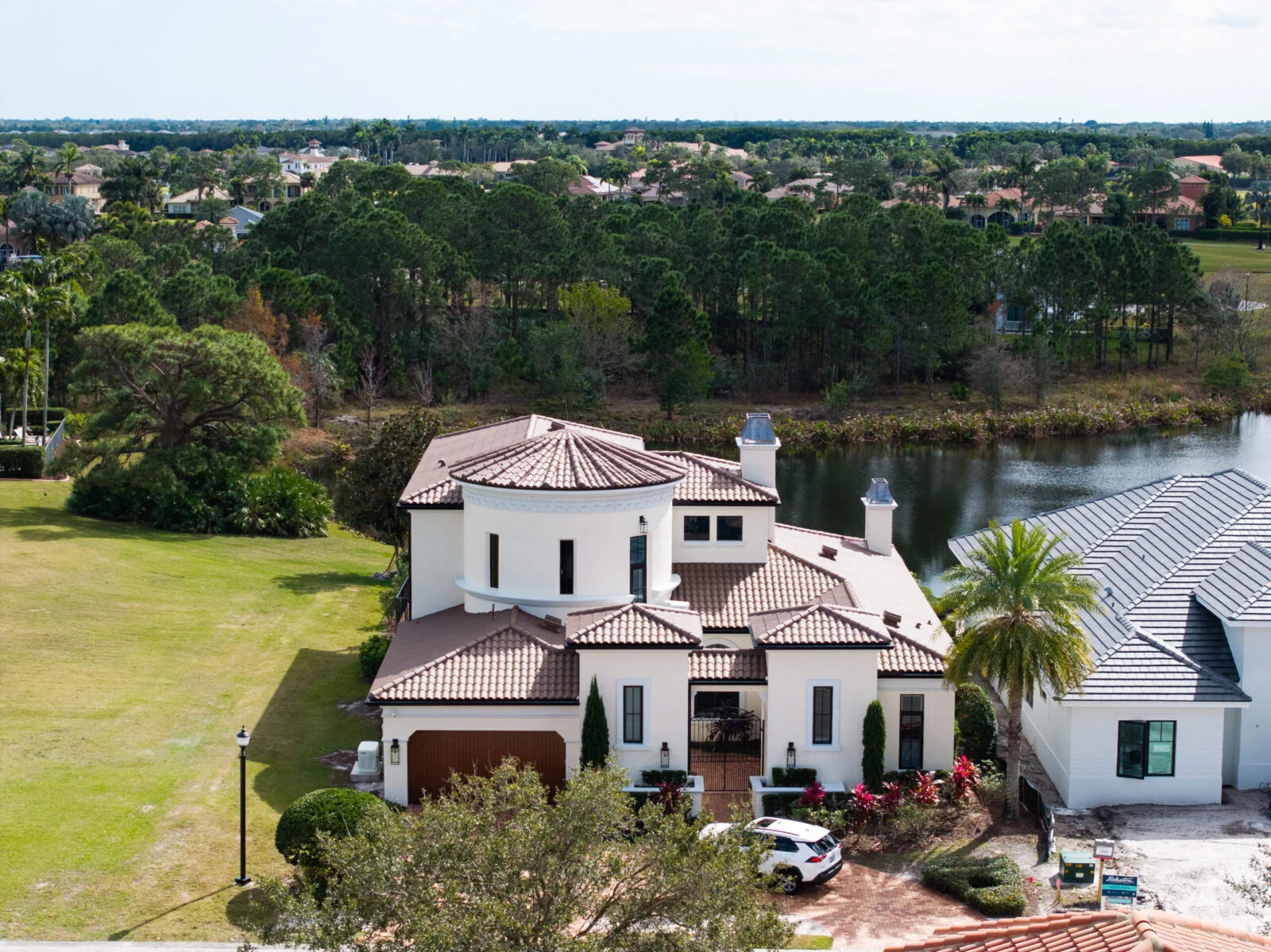 Lakefront Florida home with a terracotta tile roof